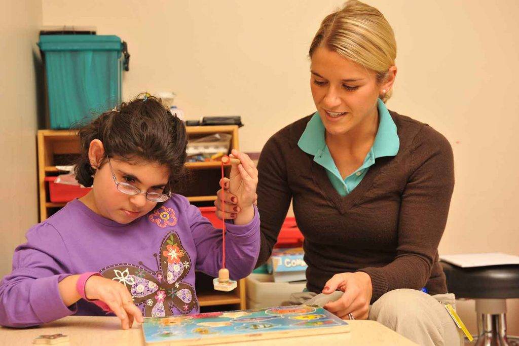 Careers for Specific Learning Disabilities - Woman Therapist Seeing A Disabled Child Client